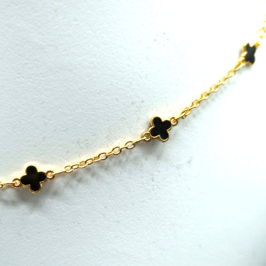 Ankle bracelet featuring small black cross charms